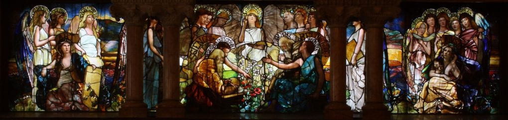 A stained glass window depicting the Greek Muses representing the different liberal arts