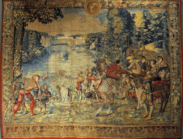 Medieval tapestry of men and women, some on horseback some on the ground, around a lake with buildings in the background